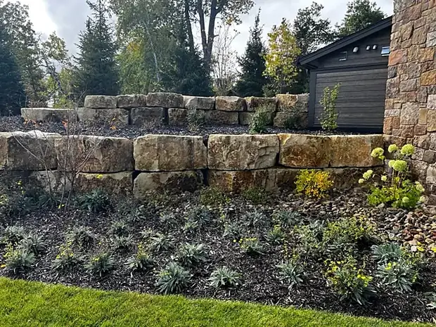 Two-course natural boulder retaining wall with a planted terrace above
